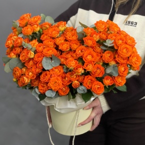 Композиция в шляпной коробке "Закат" из кустовых роз и эвкалипта в Куровском